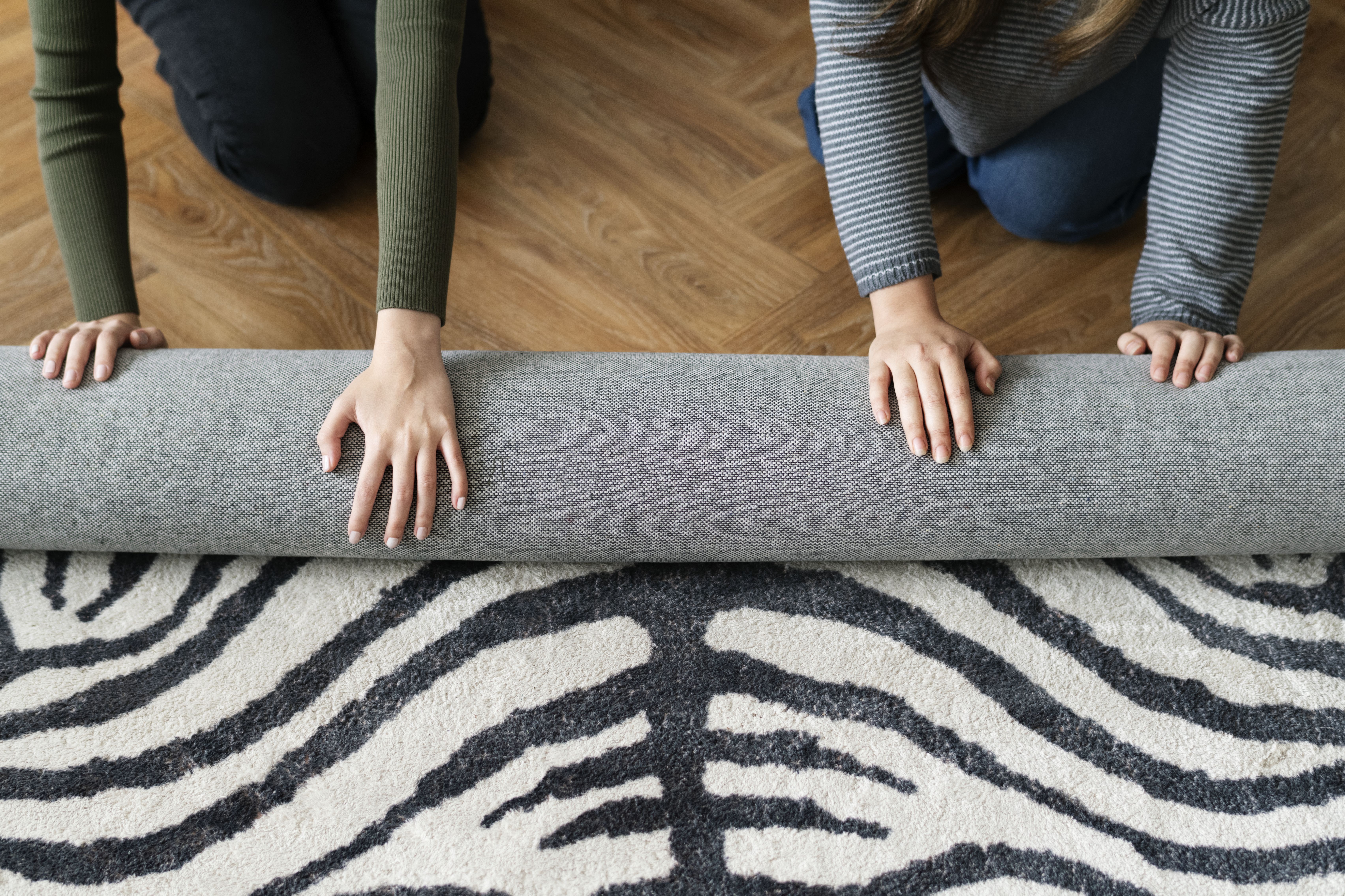 Technician cleaning a light carpet with professional equipment